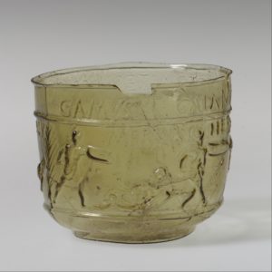 The scene around the cup depicts four pairs of gladiators fighting. Each man is identified by name in the Latin inscription above him. Some of the names match those of known gladiators who became famous in games held in Rome during the Julio-Claudian period, suggesting that such cups may have been made as souvenirs. The cup dates back to 50 - 100 A.D.