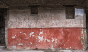 Pompeii ancient political advertising written letters painted on a house wall